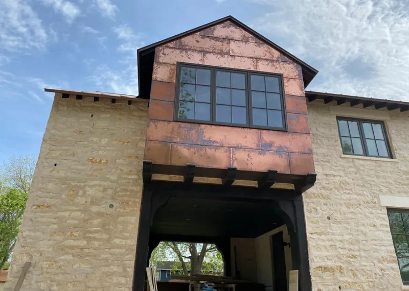 Copper metal panel facade on a stone building for Metal Roof Coating in Aldine